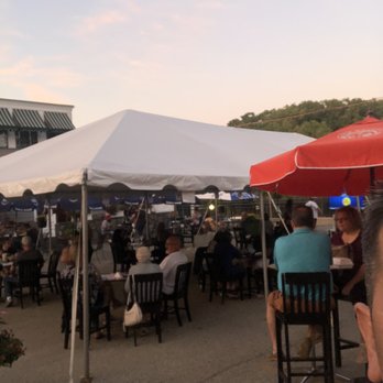 Owen and Ollie's - a crowd of people sitting at tables under umbrellas - Irish Near Me - Dracut, Massachusetts