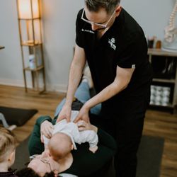 The Wellness Center Chiropractic - Dr. Kevin providing gentle infant chiropractic care -- safe adjustments for newborns and babies