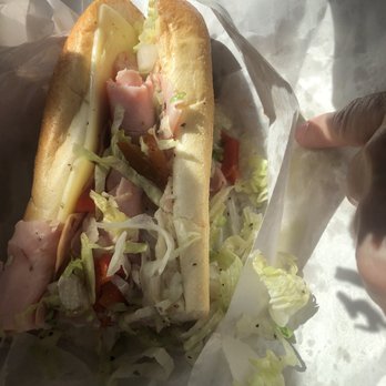 Cravings Gourmet Deli - a hand holding a sandwich - Delis Near Me - Lancaster, Pennsylvania Cravings Gourmet Deli - a hand holding a sandwich - Delis Near Me - Lancaster, Pennsylvania