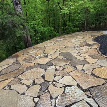 KEPs Above and Underground Contracting - Complete patio using large flagstone with a chocolate sand as joint compound. Chopped border stone for border between patio and mulch. - Gardeners Near Me KEPs Above and Underground Contracting - Complete patio using large flagstone with a chocolate sand as joint compound. Chopped border stone for border between patio and mulch. - Gardeners Near Me