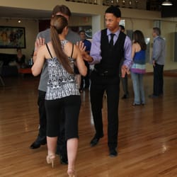 A young couple takes dance lessons to prepare for their first dance at their wedding.
