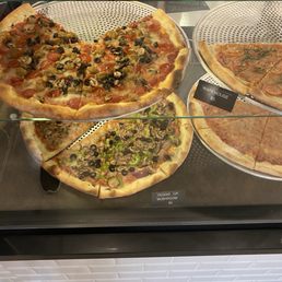 Pizzas located In their glass case in the front Pizzas located In their glass case in the front