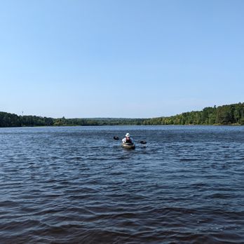 Marquette Outdoors - A guest at the Tourist Park Campground heading out for a kayak adventure on the Dead River. - Bike Rentals Near Me Marquette Outdoors - A guest at the Tourist Park Campground heading out for a kayak adventure on the Dead River. - Bike Rentals Near Me