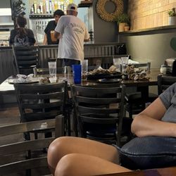 Dirty tables, worker sitting at the bar
