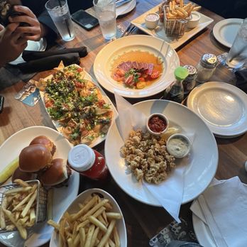Yard House - Top left -Poke Nachos, bottom left- sliders and fries from apps, top- hand battered tender and fries,  Blackened Ahi Sashimi, Fried Calamari - New American Near Me - Costa Mesa, California