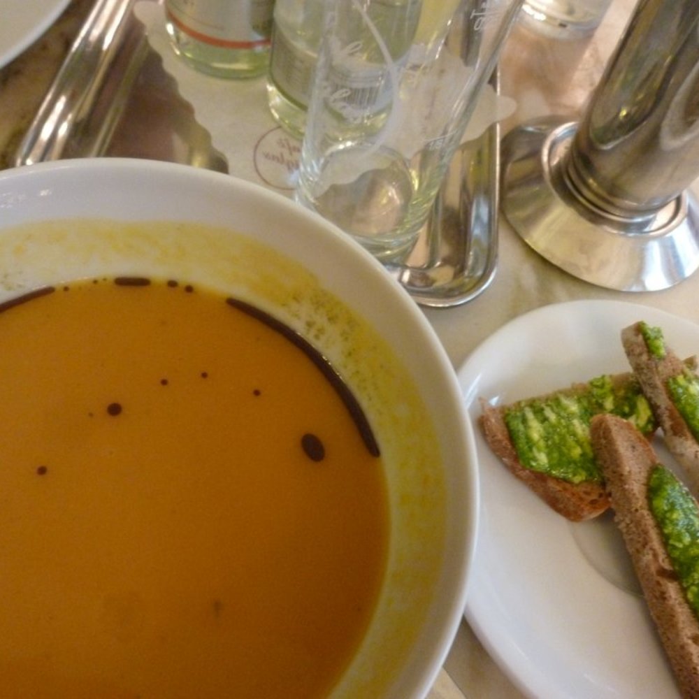 pumpkin-coconut milk soup with pesto on bread pumpkin-coconut milk soup with pesto on bread