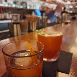 two cocktails on a bar