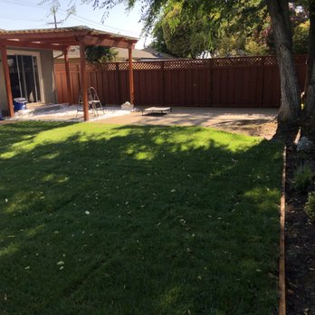 Nine Orange Landscaping - New grass, flower bed, pavers, and pergola. Don't mind the mess under the pergola; in the progress of staining it to preserve it's beauty :) - Landscaping Near Me