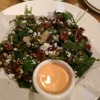 BJ's Restaurant & Brewhouse - Kale and roasted brussel sprouts salad with a side of creamy sriracha sauce. - Pizza Near Me - Slidell, Louisiana