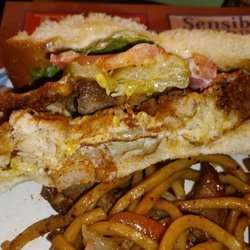 China House Restaurant - Side View of St. Paul Sandwich - House Combo Egg Foo Young Patty, lettuce, tomato, mayo on white bread