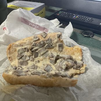 Arby's - a half eaten sandwich on a piece of paper - Fast Food Near Me - Akron, Ohio