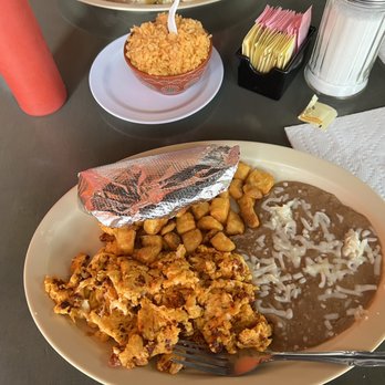 Taqueria Maria Bonita - Huevos revueltos (scrambled eggs with Chorizo, friend potatoes, refried beans) with a side of rice. - Mexican Near Me - Arlington, Texas