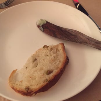 Da Claudio - Olive Bread with a paddle of butter - Italian Near Me - New York, New York Da Claudio - Olive Bread with a paddle of butter - Italian Near Me - New York, New York