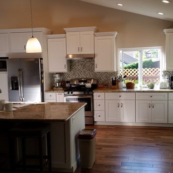 Quality Construction Solutions - Kitchen after the remodel! Led can lights Pendant lights over island Shaker style cabinets Engineered wood flooring Granite countertops - General Contractors Near Me Quality Construction Solutions - Kitchen after the remodel! Led can lights Pendant lights over island Shaker style cabinets Engineered wood flooring Granite countertops - General Contractors Near Me