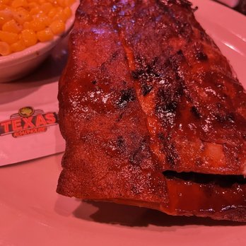 Texas Roadhouse - Half slab of ribs with delicious corn in the background - Barbeque Near Me - Rialto, California Texas Roadhouse - Half slab of ribs with delicious corn in the background - Barbeque Near Me - Rialto, California