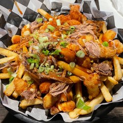 Roundhouse Brew Pub - Poutine- fries, fried cheese curds, pulled pork, gravy, and green onions.