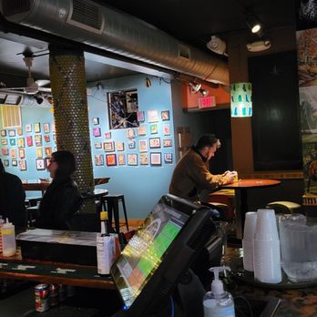 Art Bar - a man sitting at a table in a restaurant - Bars Near Me - Milwaukee, Wisconsin