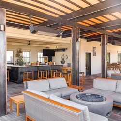 Tetto Rooftop Bar - Comfortable shaded lounge seating beneath a stylish pergola, perfect for groups or solo guests to unwind with a drink in hand.