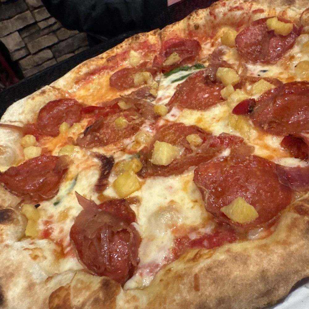 Flour Dust Pizza - "Bros Hawaiian" - tomato sauce, mozzarella, charred pineapple, candied Fresno chili peppers and onions, pepperoni, and Parmesan cheese. - Pizza Near Me - Roseville, California Flour Dust Pizza - "Bros Hawaiian" - tomato sauce, mozzarella, charred pineapple, candied Fresno chili peppers and onions, pepperoni, and Parmesan cheese. - Pizza Near Me - Roseville, California