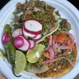 Taco de tripas (top) and taco de cochinita (bottom). Taco de tripas (top) and taco de cochinita (bottom).