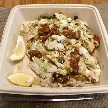 First Watch - Pesto power bowl to go. - A takeout container contains a chicken pesto power bowl with grilled chicken, sun-dried tomatoes, cheese, and herbs, served over grains. - Breakfast & Brunch Near Me - Uniontown, Ohio