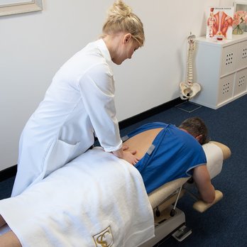 Spine Clinic - Dr Sarah Parkes (DC) performing a back adjustment - Chiropractors Near Me - Neath, NTL Spine Clinic - Dr Sarah Parkes (DC) performing a back adjustment - Chiropractors Near Me - Neath, NTL