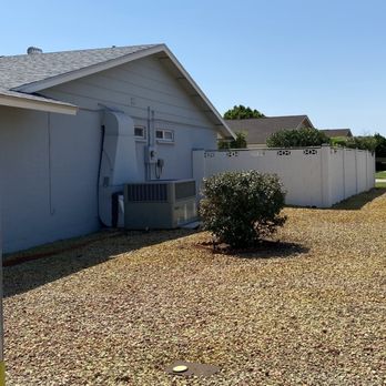 Cosio's Landscaping - a yard with a white fence and air conditioner - Lawn Services Near Me