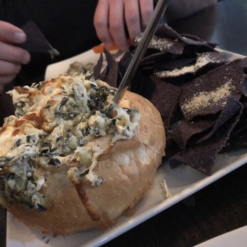 Plae Bistro - Spinach and Artichoke Dip baked in a bread bowl with tortilla chips and veggies. Enough to feed 4-6!! - New American Near Me - Green Bay, Wisconsin