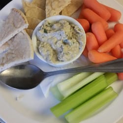 Hummus wit pita bread, celery and carrots.