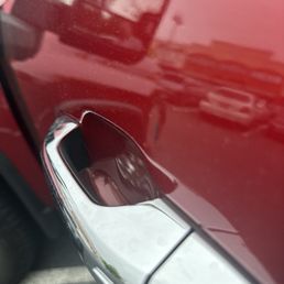Dent right above the door handle with a large black mark to go with. Dent right above the door handle with a large black mark to go with.