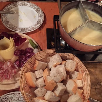 Restaurant Vieux-Chalet - Our fondue and plate of cured meats for dipping. The best post-skiing meal!!! - Swiss Food Near Me - Saas Fee, VS Restaurant Vieux-Chalet - Our fondue and plate of cured meats for dipping. The best post-skiing meal!!! - Swiss Food Near Me - Saas Fee, VS