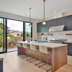 Cabinets & Beyond Design Studio - BELLMONT 1900 . Walnut slab veneer door and black slab door