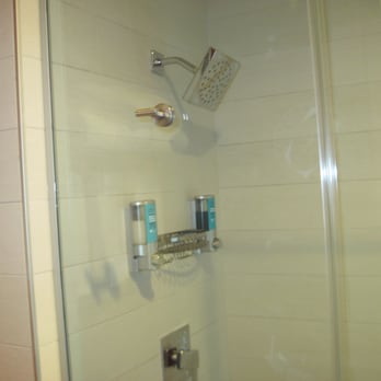 Aloft by Marriott College Station - large shower head; All in one shampoo/conditioner on the left and body wash on the right - Hotels Near Me - College Station, Texas