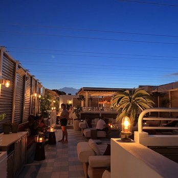 The Roof - people sitting at tables on a rooftop - Bars Near Me - Miami Beach, Florida The Roof - people sitting at tables on a rooftop - Bars Near Me - Miami Beach, Florida