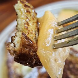 Renee’s Family Restaurant - A fork with a piece of French Toast, Cantaloupe, and  syrup.
