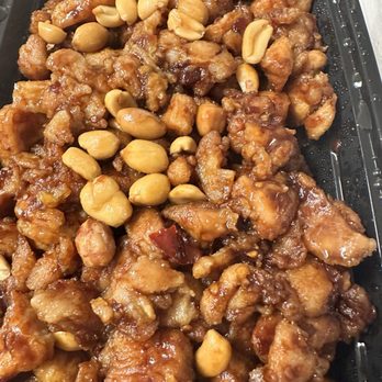 Chau's Cafe - Kung Pao Chicken - Chicken stir-fry with peanuts in a sauce, served in a black takeout container. - Chinese Near Me - Ashburn, Virginia