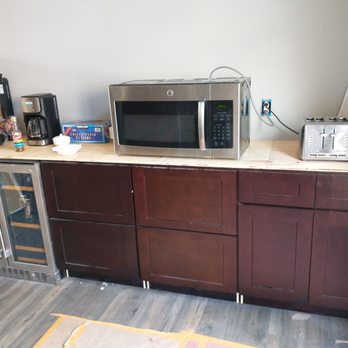 Floors To Ceiling Construction - Unfinished cabinets, no countertops, no covers on outlets. - General Contractors Near Me