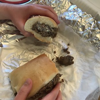 Tonys Pizza - a person taking a bite out of a sandwich - Pizza Near Me - Coopersburg, Pennsylvania Tonys Pizza - a person taking a bite out of a sandwich - Pizza Near Me - Coopersburg, Pennsylvania