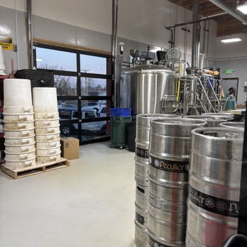 Peculier Ales - Peeking through the glass at where the magic happens - Breweries Near Me - Windsor, Colorado
