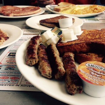 Americana Diner - Foreground: French toast with sausage, Background: American cheese omelet with a side of ham and scrapple - American Near Me - Bechtelsville, Pennsylvania Americana Diner - Foreground: French toast with sausage, Background: American cheese omelet with a side of ham and scrapple - American Near Me - Bechtelsville, Pennsylvania