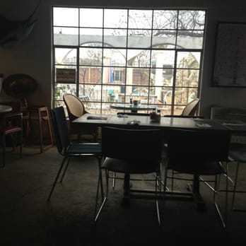 Jazz Cafe - a table and chairs in front of a large window - Greek Near Me - Fort Worth, Texas Jazz Cafe - a table and chairs in front of a large window - Greek Near Me - Fort Worth, Texas