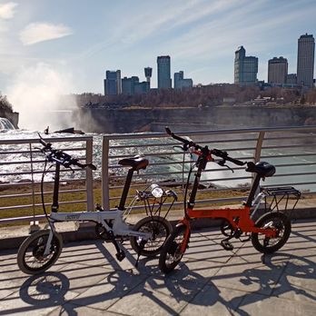Citizen Bike - our eBikes at Niagara Falls State Park's at the Discovery Center with Niagara Falls, Canada in the background - Bikes Near Me - Dania Beach, Florida
