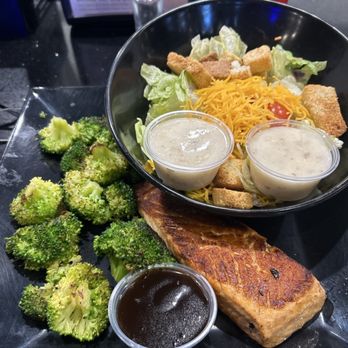 The GOAT Bar & Grill - Grilled salmon and broccoli with a side salad - Bars Near Me - Prattville, Alabama The GOAT Bar & Grill - Grilled salmon and broccoli with a side salad - Bars Near Me - Prattville, Alabama