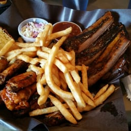 1/2 rack of ribs & 1/2 pound of smoked wings in signature sauce with amazing fries, beans and coleslaw. 1/2 rack of ribs & 1/2 pound of smoked wings in signature sauce with amazing fries, beans and coleslaw.