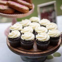 Sweet Dreams Gourmet Bakery - Chocolate cupcakes with vanilla buttercream and (to the right) red velvet cupcakes with cream cheese buttercream.