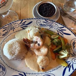 Salmon with shrimp and scallops in a white creamy sauce with black beans and vegetables Salmon with shrimp and scallops in a white creamy sauce with black beans and vegetables