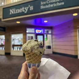 Exterior outside entrance of Ninety’s Dessert Bar - Cookies and cream single scoop in a waffle cone - Charlotte, North Carolina Exterior outside entrance of Ninety’s Dessert Bar - Cookies and cream single scoop in a waffle cone - Charlotte, North Carolina