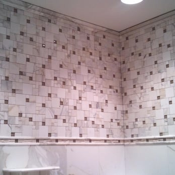 Mosaic Marble Shower With Marble Crown Molding And Marble Chair