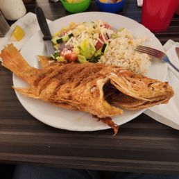 Whole fried red snapper, seasoned rice, salad. Whole fried red snapper, seasoned rice, salad.