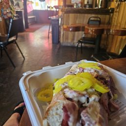 Pastrami on toasted roll with Swiss cheese, pickles and peppercinis Pastrami on toasted roll with Swiss cheese, pickles and peppercinis